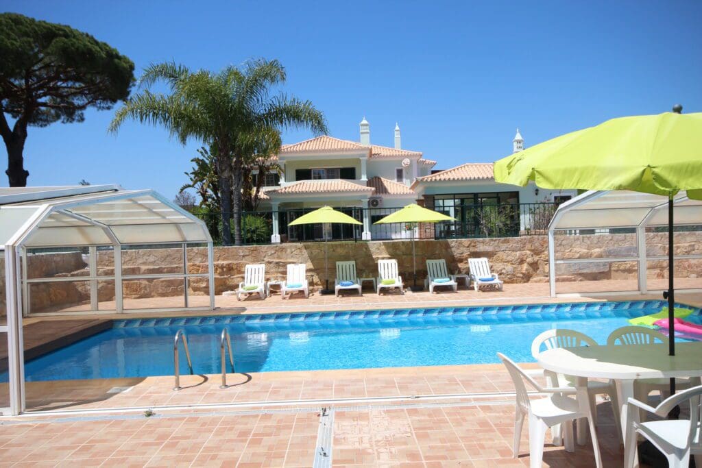 5 Bedroom Villa Joy swimming pool with chairs and umbrellas next to it